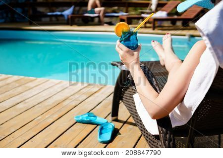 Relaxing Woman Near Luxury Swimming Pool.