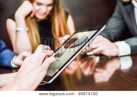 Business Team Using Tablet Computer To Work With Financial Data