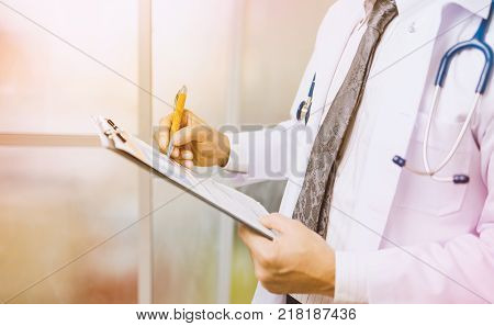 Close up Of Hand Male Doctor Filling The Medical Form. Close-up Of Male Doctor Filling The Medical Form. Doctor writting. Uniform doctor. Doctor man. Doctor woman. Doctor paperwork. Pen in hand doctor.