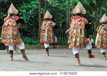 Three Men In Traditional Costumes Perform A Balinese War Dance Called Tari Baris Gede Outdoors. Danc