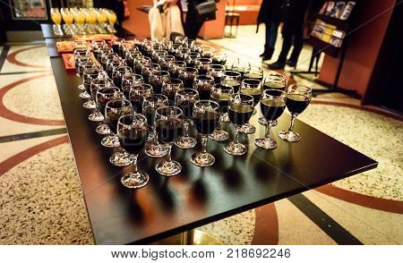 Glasses Of Red Wine On A Table At A Party.