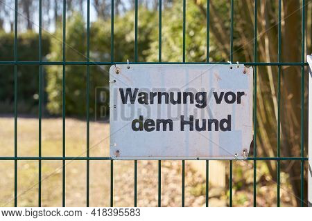 Sign On A Fence In Germany With The Inscription 