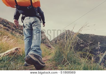 Adventure man hiking wilderness mountain with backpack, outdoor lifestyle survival vacation