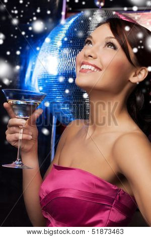 luxury, vip, nightlife, party, christmas, x-mas, new year's eve concept - beautiful woman in evening dress with cocktail and disco ball