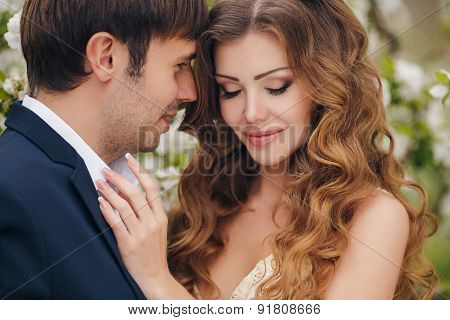 The bride and groom - photo in a flowery Park in the spring.