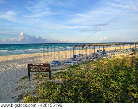 Cayo Coco, Cuba, 16 May 2021: Sandy Beach Of The Hotel Tryp Cayo Coco With Sun Loungers And Tall Pal