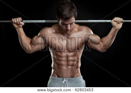 Muscular Bodybuilder Guy Doing Exercises With Dumbbells Over Black Background