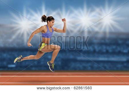 Female sprinter running in stadium