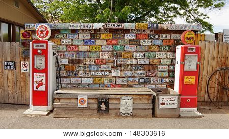 Gas pump stand museum and Historical automobile registration tags. Utah USA. May 20, 2016