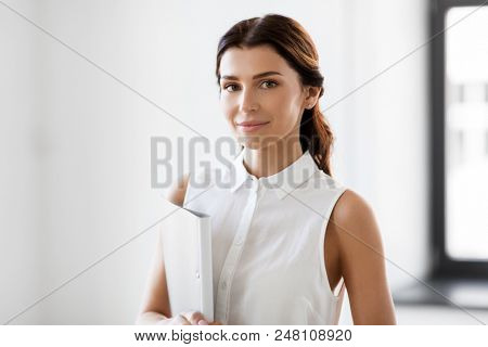 business, people and corporate concept - businesswoman or realtor with folder at office