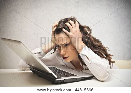 stressed businesswoman looks laptop