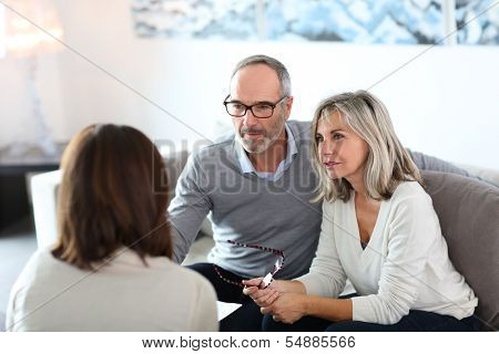 Senior couple meeting financial adviser for investment