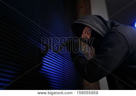 Robber with picklock at night