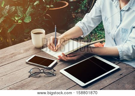 Young Business Woman Hand With Pencil Writing On Notebook. Woman Hand With Pencil Writing On Noteboo