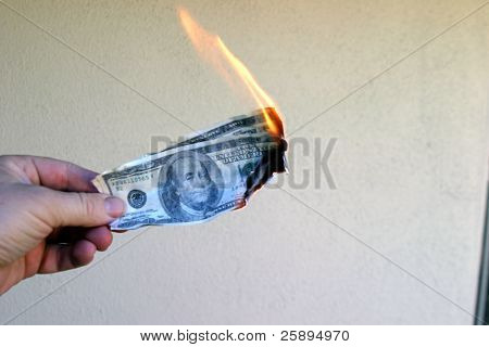 Money To Burn!
A hand holding a One Hundred Dollar Bill on fire.