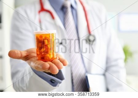 Male Medicine Doctor Hand Holding And Offering To Patient Jar Of Pills. Medical Care Prescription Ph