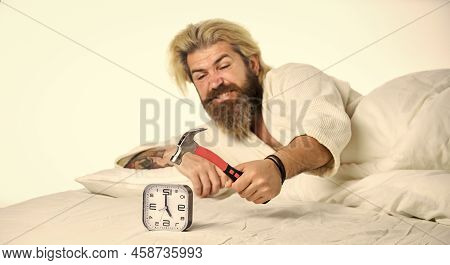 Time Management. Time To Wake Up. Exhausted Man Being Awakened By Alarm Clock In Bedroom. Mature Man