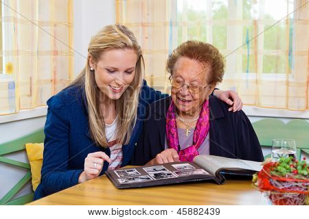 a grandchild visiting his grandmother. view the photo album.