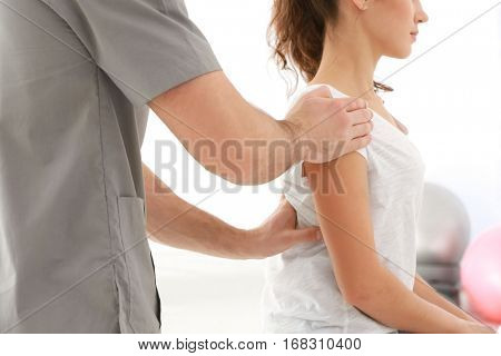 Physiotherapist working with patient in clinic, closeup