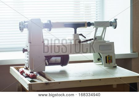 Woodworking Machine, Mini Woodworking Lathe Close Up Detail, Wood Shavings Tools, Woodworking Machinery, Small Woodwork Lathe in a Joinery Workshop, Woodwork on the Machine, Spindle Turning