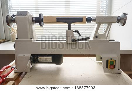 Woodworking Machine, Mini Woodworking Lathe Close Up Detail, Wood Shavings Tools, Woodworking Machinery, Small Woodwork Lathe in a Joinery Workshop, Woodwork on the Machine, Spindle Turning