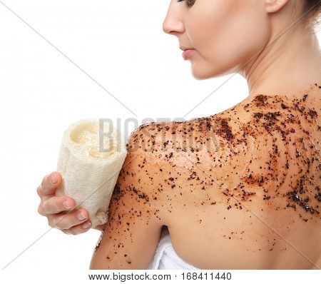 Young woman using wisp and scrub on white background, closeup