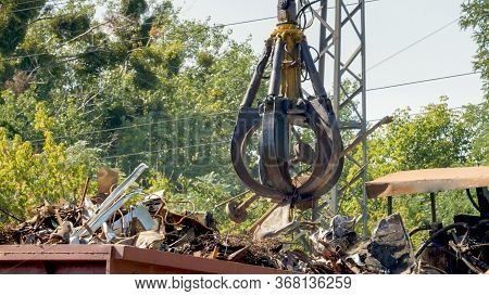 Image Of Metal Claw Lifting Metal On Scrapyard