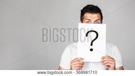 Portrait Of Man, Peeking Behind Of Interrogation Symbol. Question Mark, Symbol. Pensive Male. Man A 