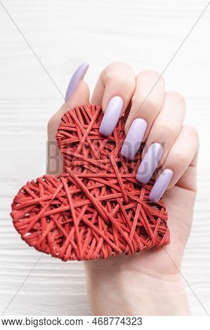 Girl's Hands With Delicate Purple Manicure And Decoratine Heart