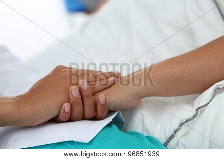 Friendly Female Doctor Hands Holding Patient Hand