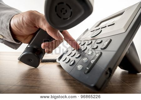 Global Communication Concept - Closeup Of Male Hand Dialing A Telephone Number In Order To Make A Ph