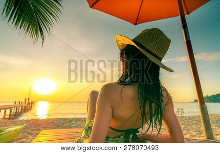 Sexy, Enjoy And Relax Caucasian Woman Wear Bikini Lying And Sunbathing On Sunbed At Sand Beach At Pa