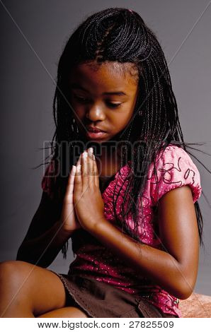 Portrait of a Young African American girl praying