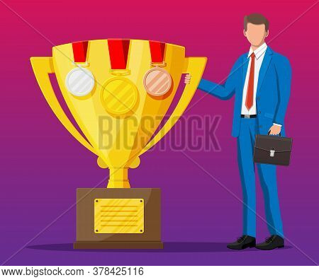 Successful Businessman Near Big Gold Trophy Cup With Medals, Celebrates His Victory. Business Succes