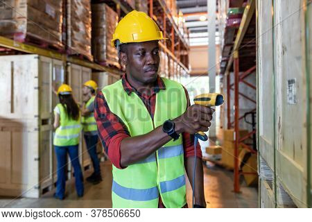 Portrait of african black warehouse worker hold hand scanner to do inventory work stock in distribution warehouse. Traceability FIFO LIFO inventory just in time and warehouse concept photo.