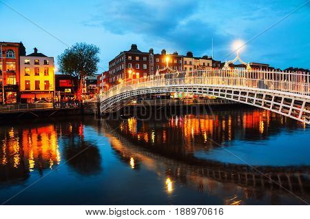 Dublin, Ireland. Night view of famous illuminated Ha Penny Bridge in Dublin, Ireland