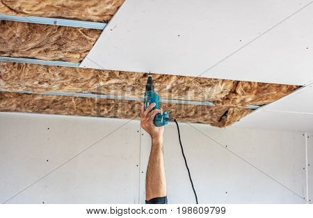 Fixing plasterboard sheets to the frame. plasterboard