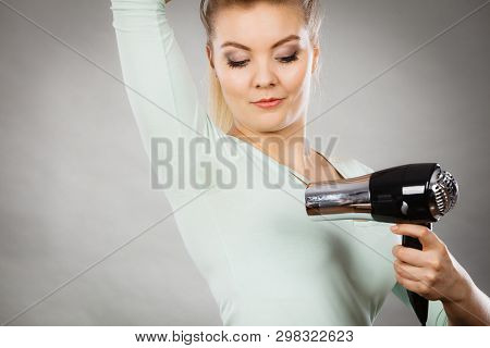 Woman Drying Wet Armpit Using Hair Dryer. Getting Rid Of Sweat And Bad Smell, Hyperhidrosis.