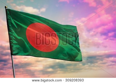 Fluttering Bangladesh Flag On Colorful Cloudy Sky Background. Bangladesh Prospering Concept.