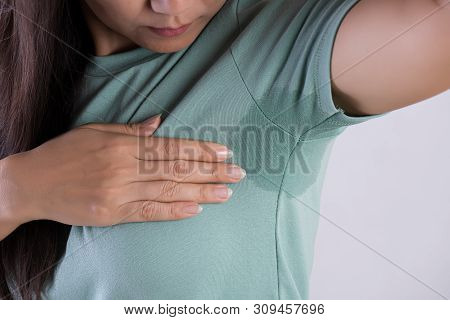 Close-up Asian Woman With Hyperhidrosis Sweating. Young Asia Woman With Sweat Stain On Her Clothes A