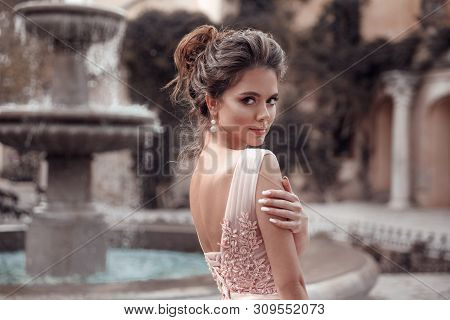 Beautiful Bride With Pearl Earrings Jewelry Wears Pink Prom Dress. Outdoor Romantic Portrait  Of Att