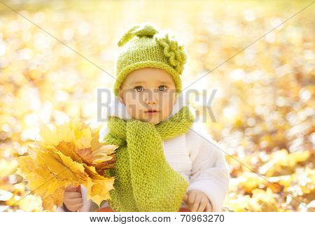 Autumn Baby Portrait In Fall Yellow Leaves, Little Child In Woolen Hat, Beautiful Kid In Park