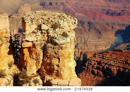 Sunlit Rock Formation with Colorado River below at Grand Canyon