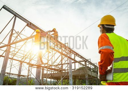 A Construction Worker Control In The Construction Of Roof Structures On Construction Site And Sunset