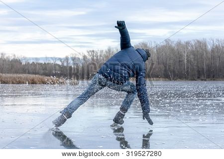 Skating On The Lake. Man Falling Down While Ice Skating. Ice Skating Outdoors On A Pond Or River. Vi