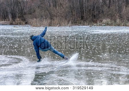 Skating On The Lake. Man Falling Down While Ice Skating. Ice Skating Outdoors On A Pond Or River. Vi