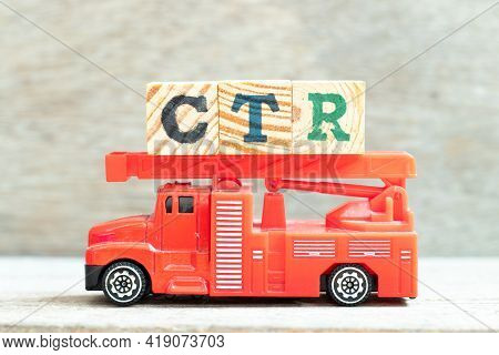 Fire Ladder Truck Hold Letter Block In Word Ctr (abbreviation Of Click Trough Rate) On Wood Backgrou