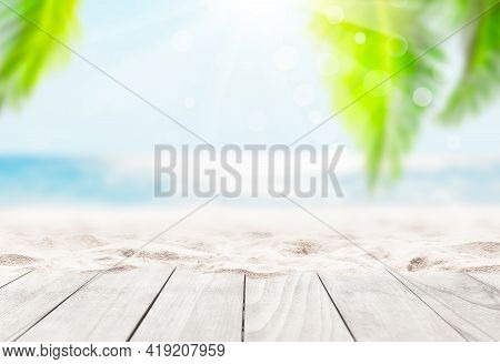 Wooden Table Top On Blue Sea And White Sand Beach Background. Coconut Palm Trees Against Blue Sky An