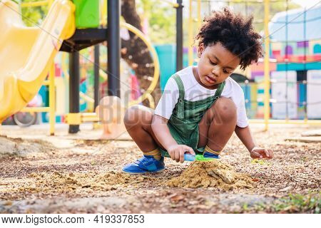 Cute African American Little Kid Boy Having Fun While Playing On The Playground In The Daytime In Su