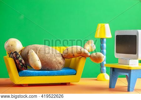 A Quirky Metaphorical Concept Image Showing A Potato Man Lying On A Couch Watching Tv In A Living Ro